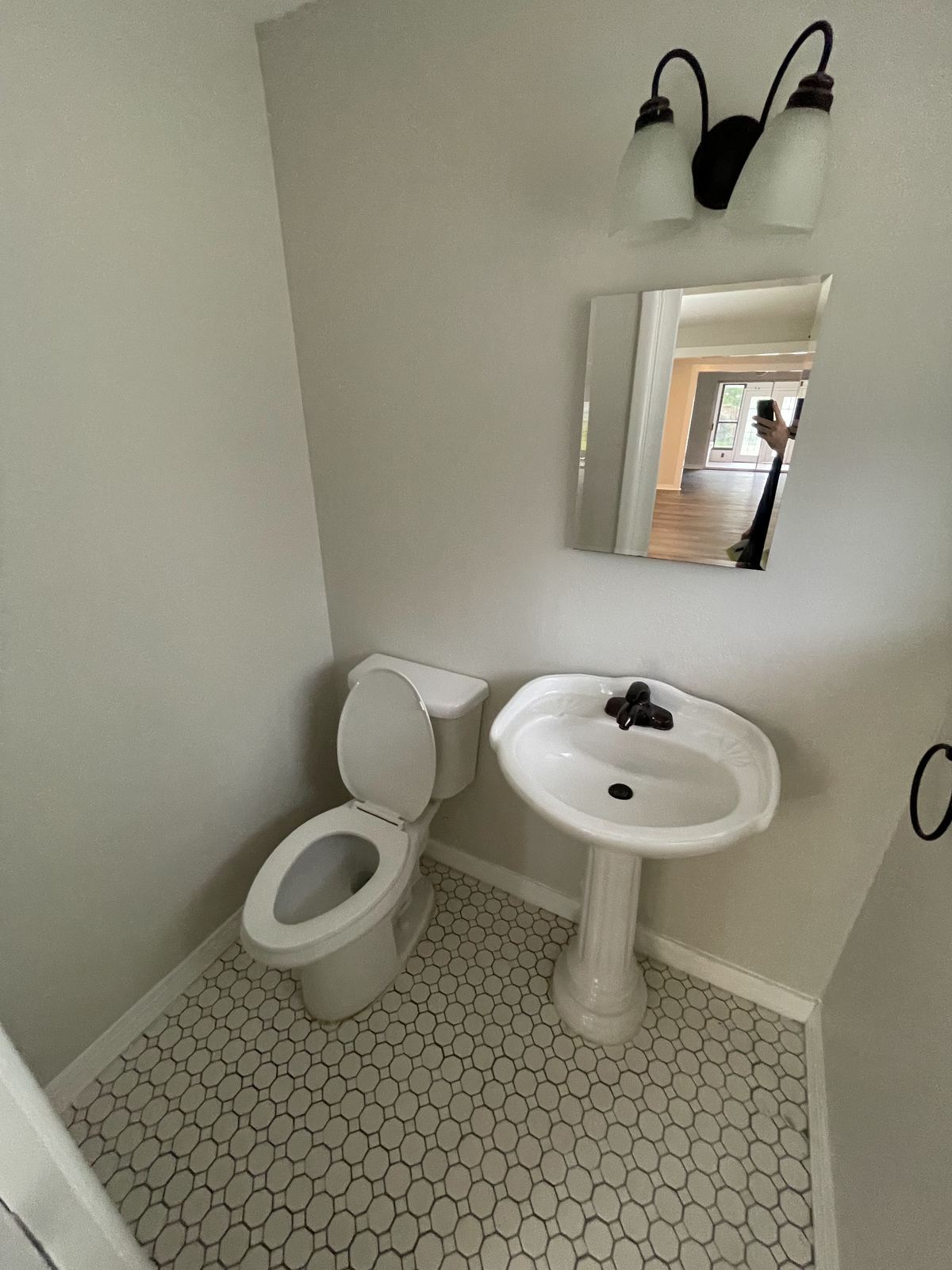 New bathroom with pedestal sink and hex tile floor
