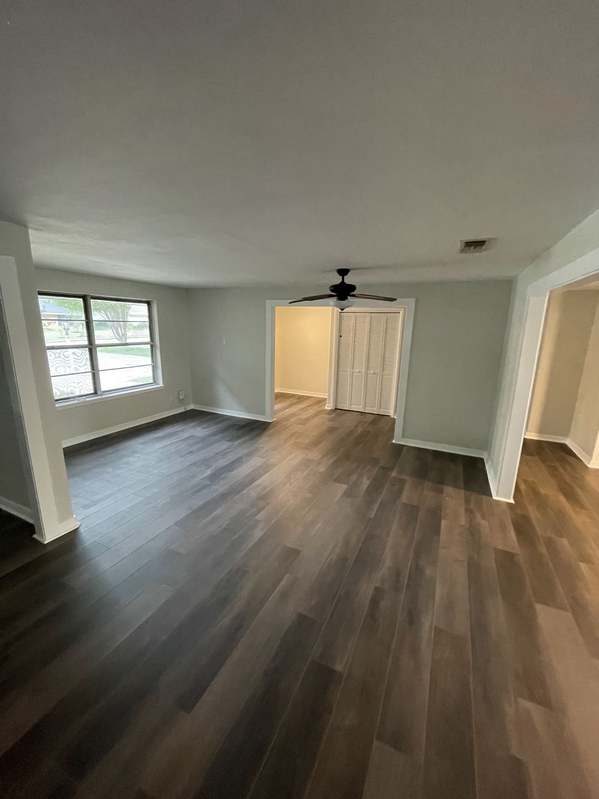 Renovated bedroom with ceiling fan and new flooring