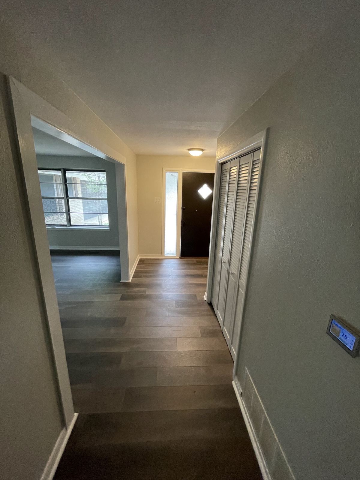 Hallway with new flooring leading to living area