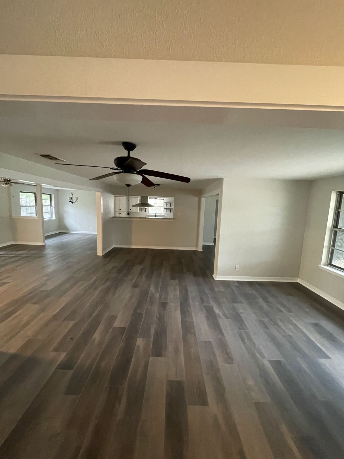 Renovated open living room with new wood floors