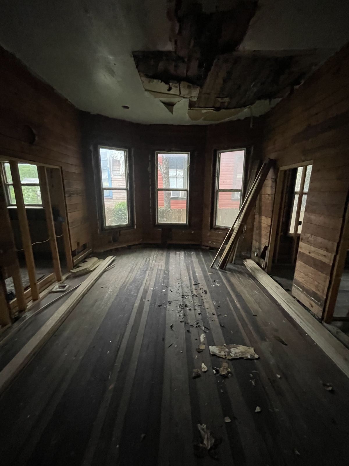 Historic house interior stripped to studs at bay window
